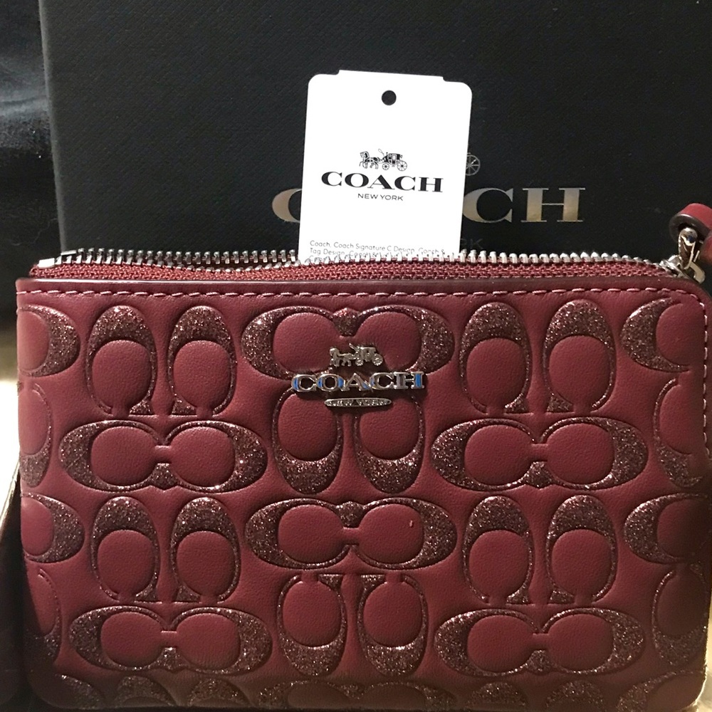 Magenta coach wristlet. Has glitter offset.